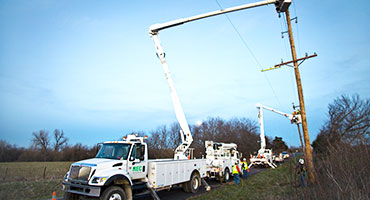 REC Utility crew reconductoring a distribution line.
